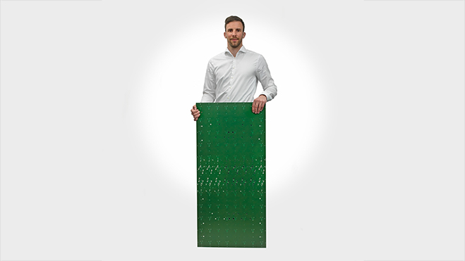 Remo Rutz holds a circuit board in XXL format